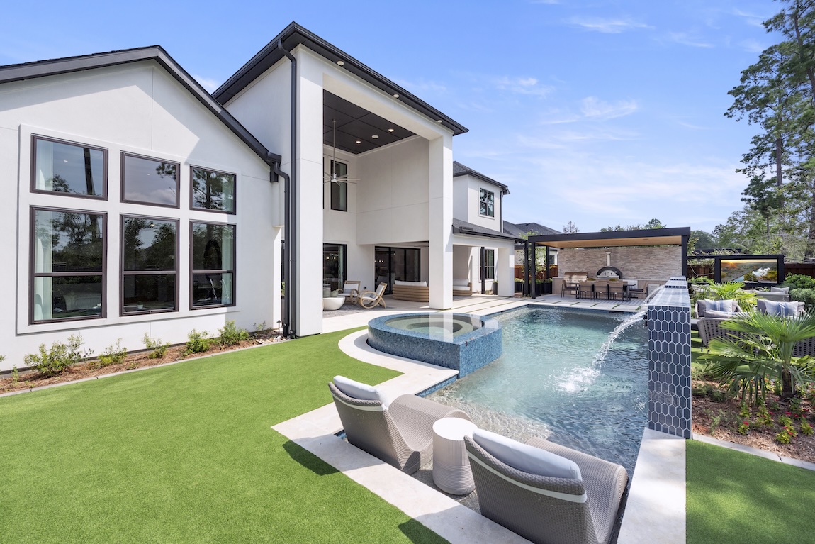 outdoor living space with pool and outdoor kitchen and dining