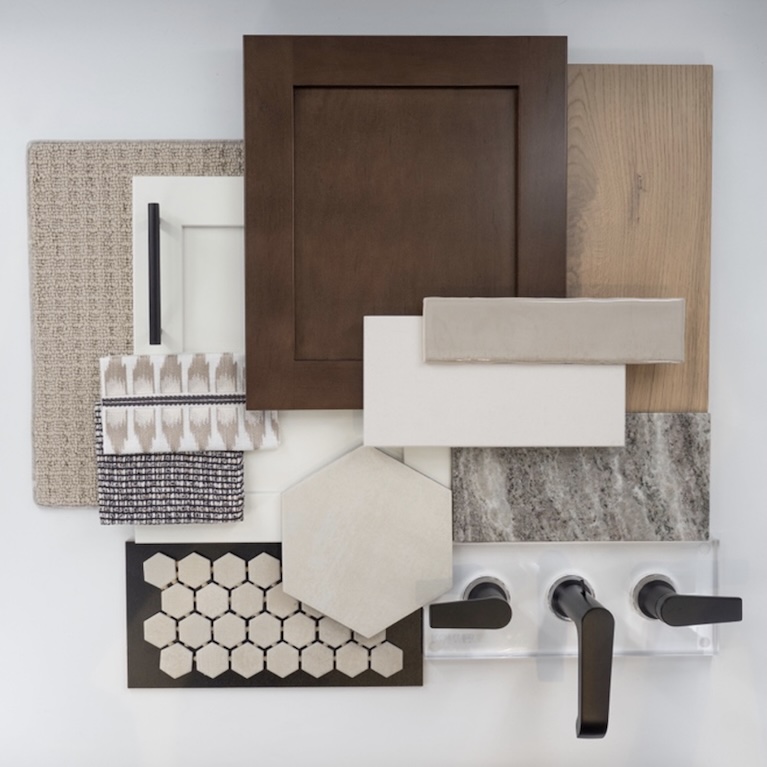 Warm transitional bathroom material palette with medium-tone wood, soft stone surfaces, textured fabrics, hex tile, and dark metal fixtures.