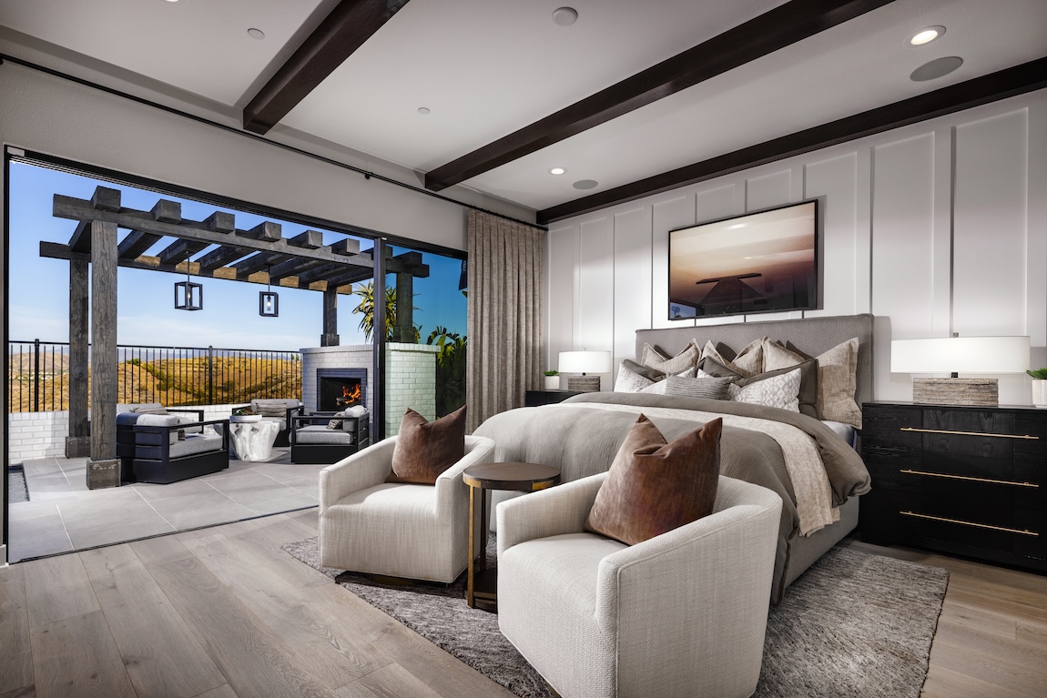 primary bedroom with outdoor seating space and fireplace