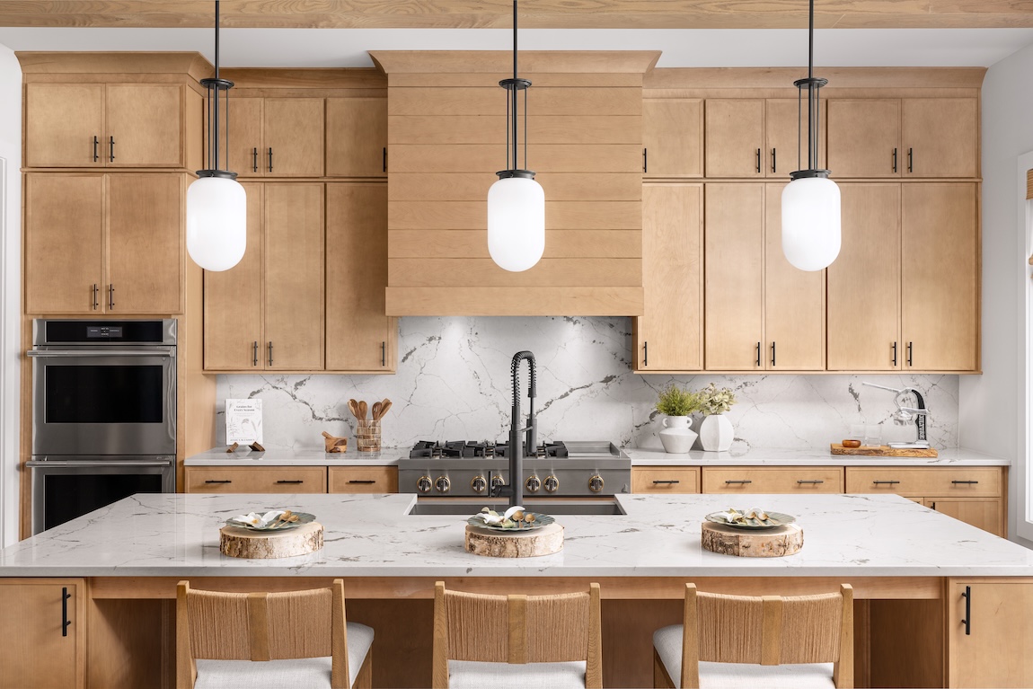 modern kitchen with wooden cabinetry and marble countertops