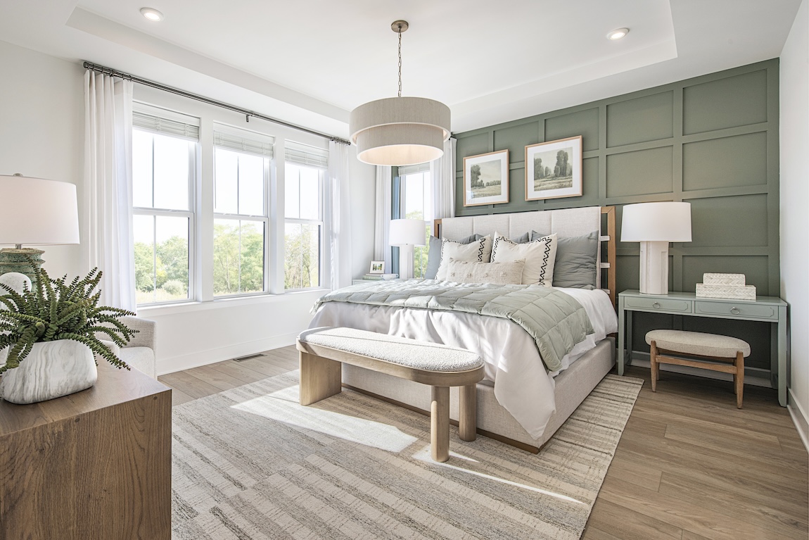 primary bedroom with a green accent wall