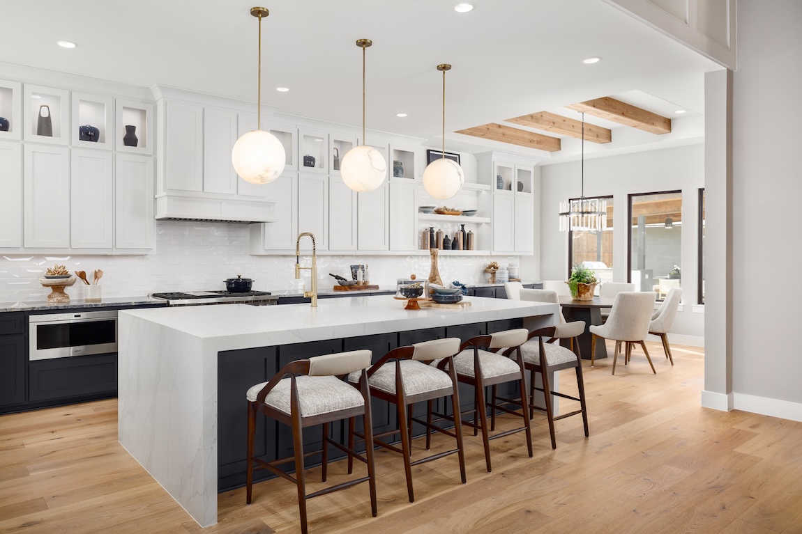 modern kitchen with waterfall island and white cabinetry