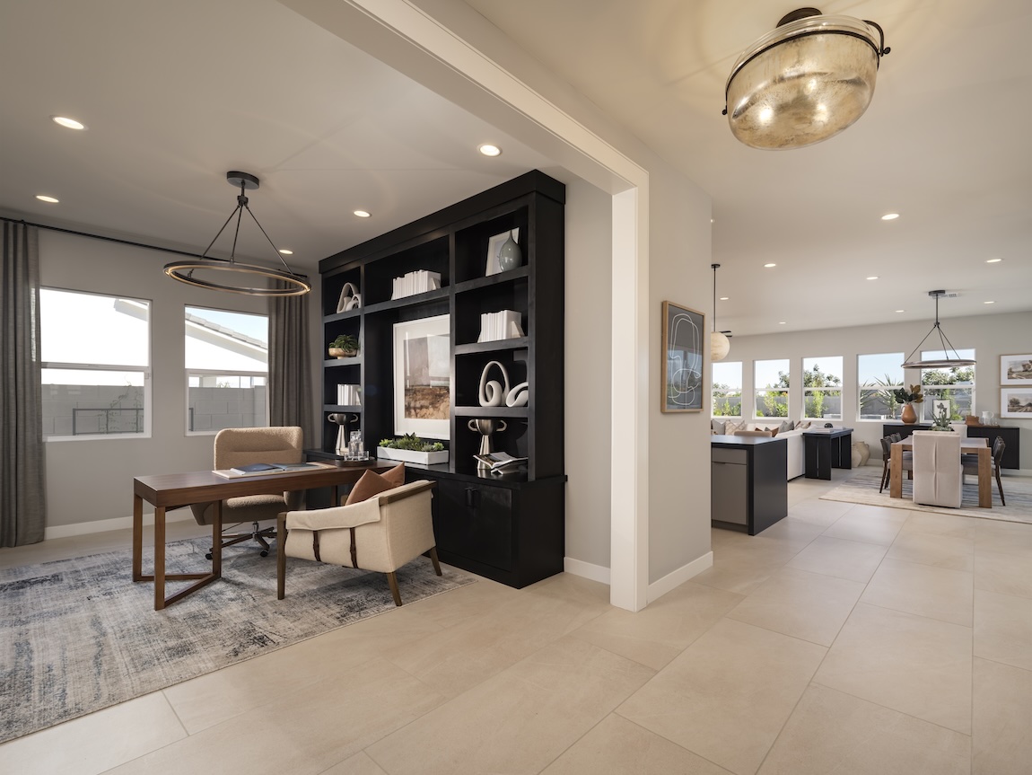 Home office with built-in shelving and open sightlines, featuring neutral walls for a warm, cohesive design.