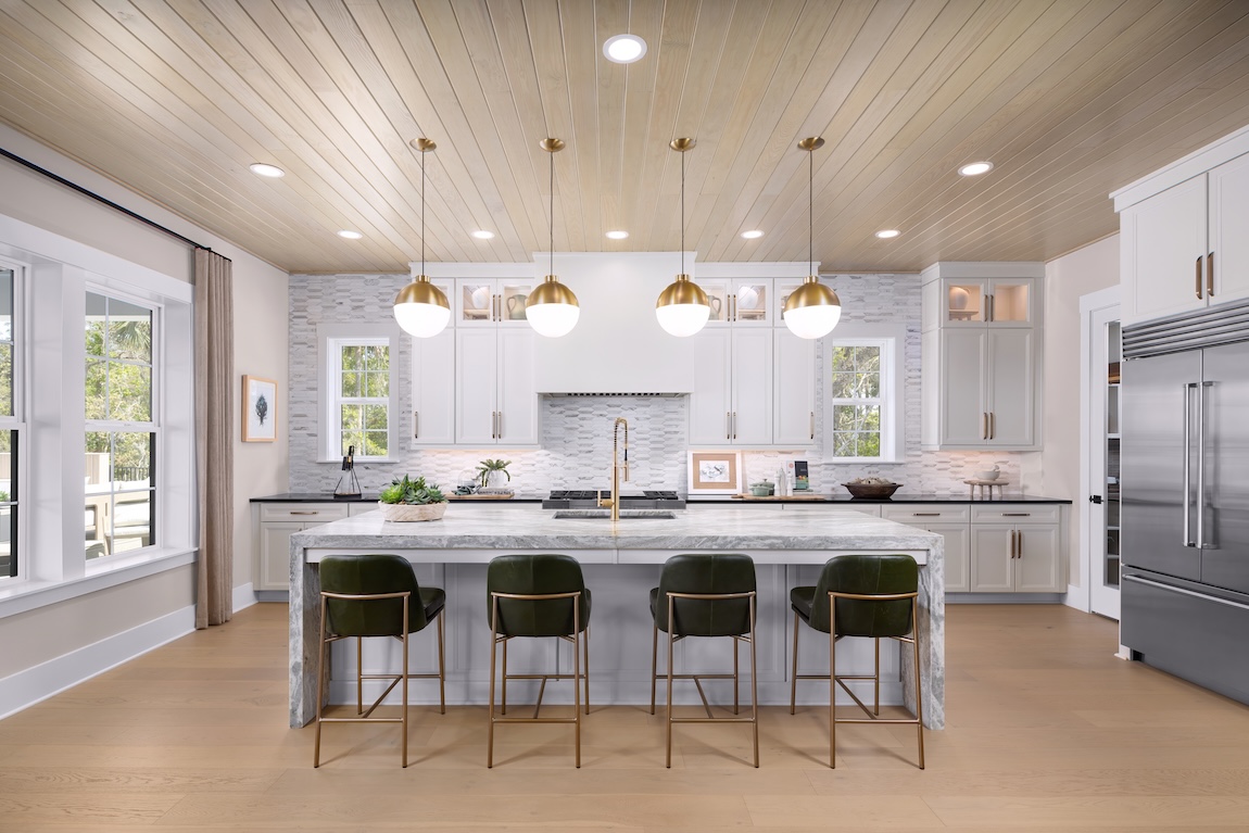 luxury kitchen with waterfall island and statement gold lighting overhead