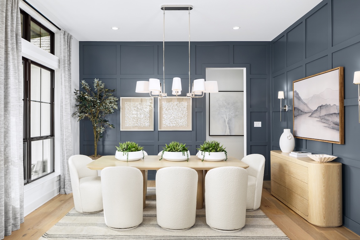modern dining room with dark blue walls and greenery