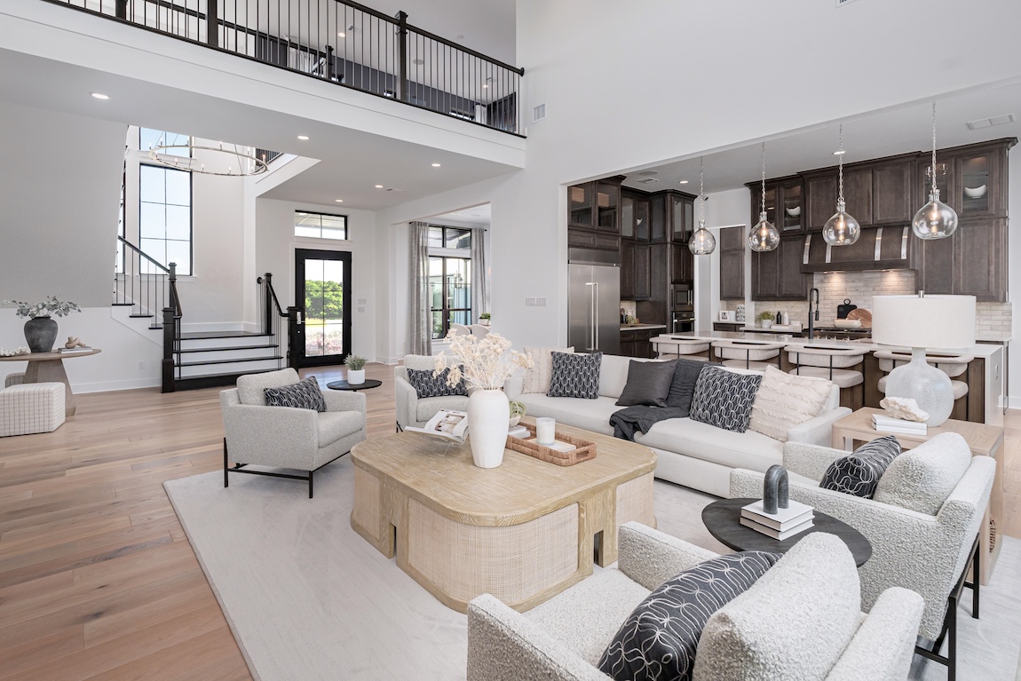 great room and kitchen with patterned features and dark wood cabinetry