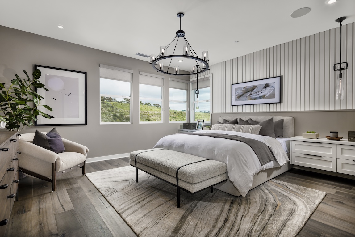 primary bedroom with accent wall behind the bed.