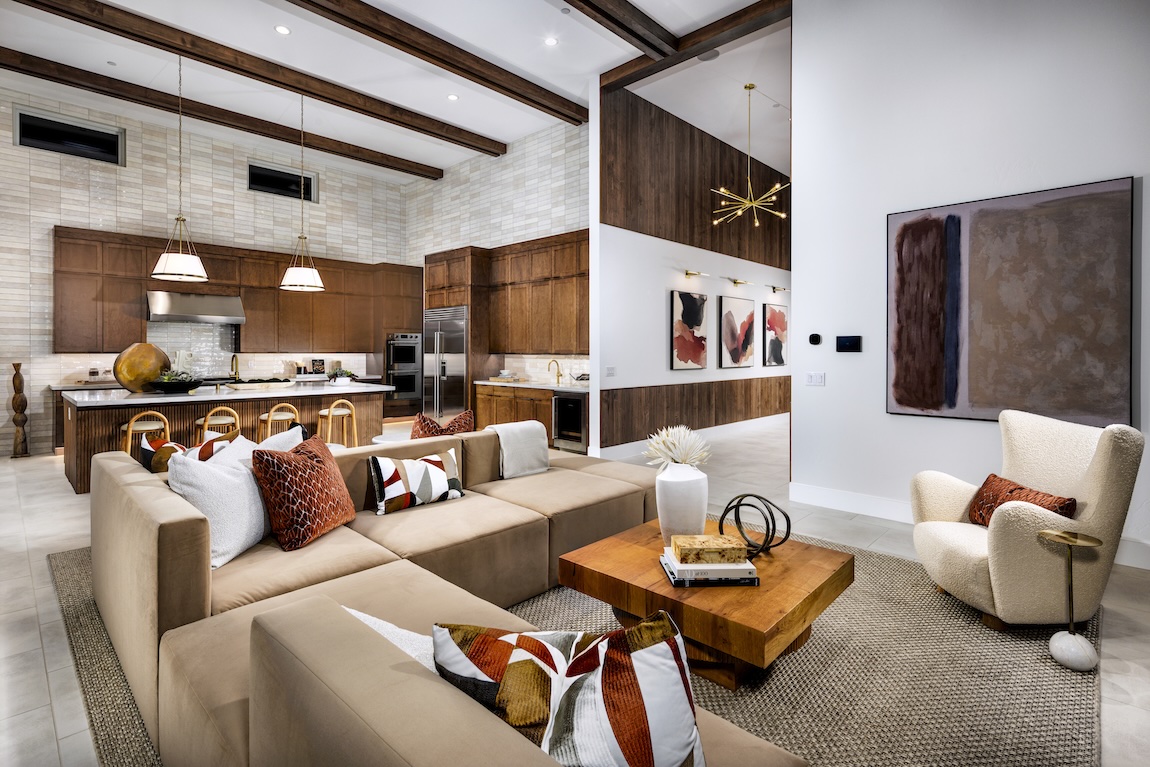 Tuscan-style interior featuring warm wood kitchen cabinetry, exposed beams, and an open-concept living space.