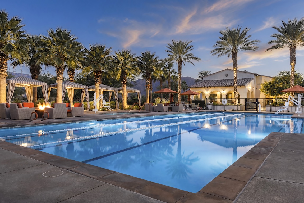 amenity pool and clubhouse with seating cabanas and a fire pit
