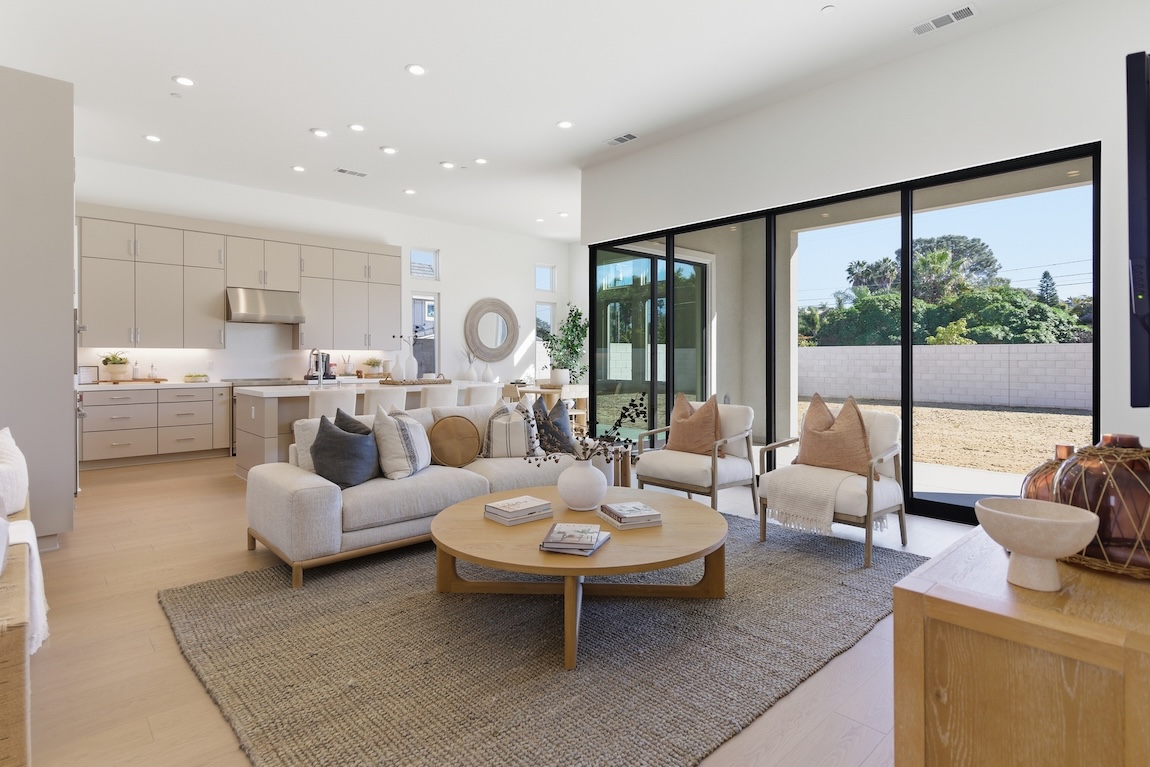 Living room with comfortable seating and glass doors to the outdoor living space.