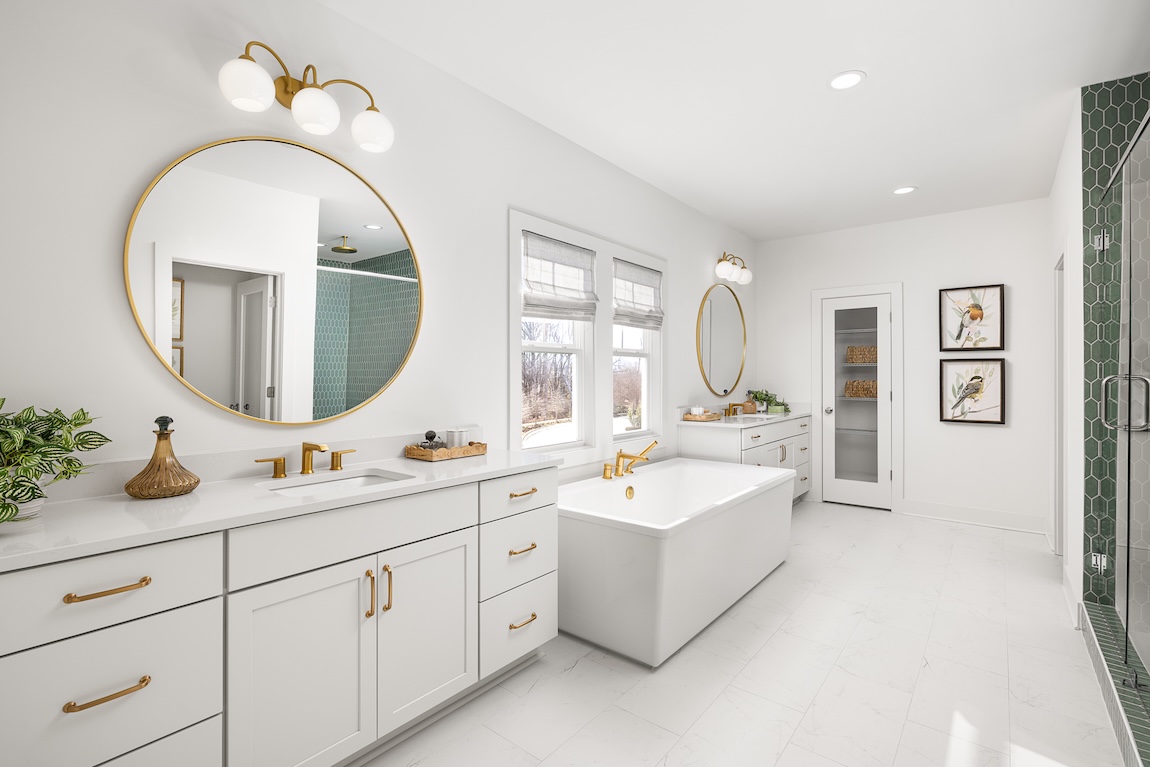 Primary bathroom with freestanding tub and a green tile shower.