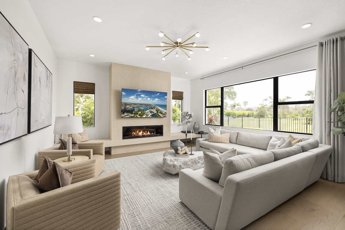 Modern great room with a large sofa and luxury fireplace.