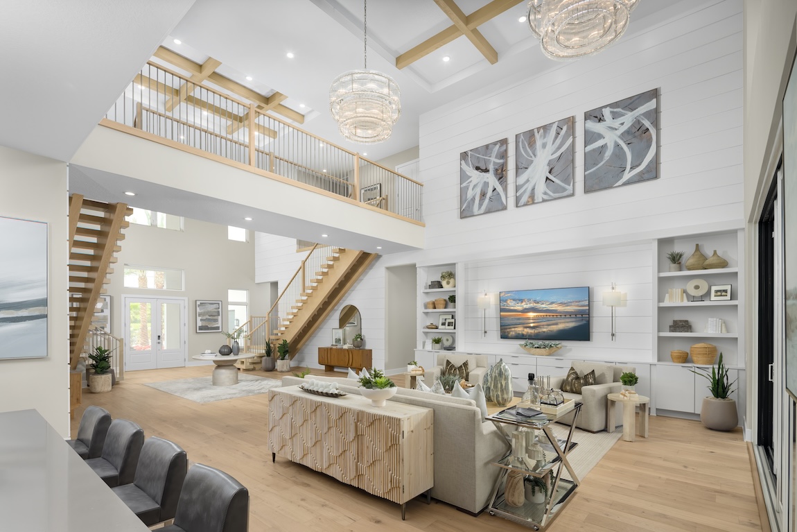 modern living room with views of the dual staircase and entryway