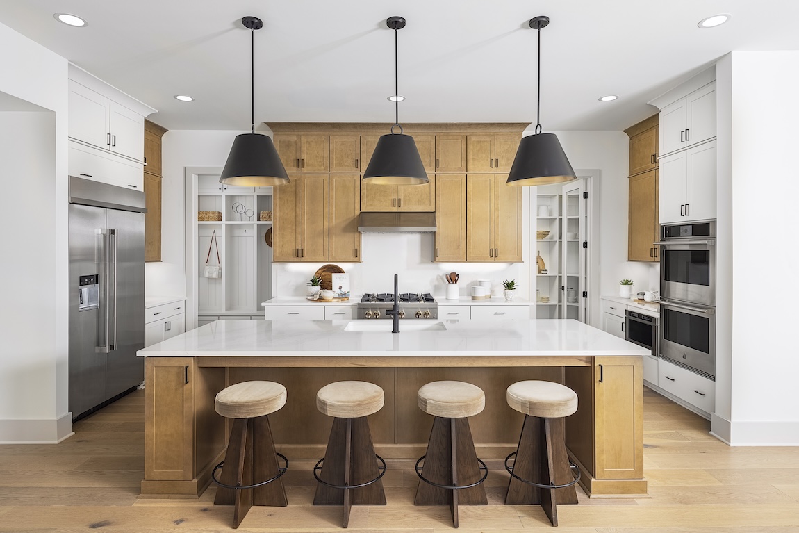 Modern kitchen with wooden cabinetry and white countertops
