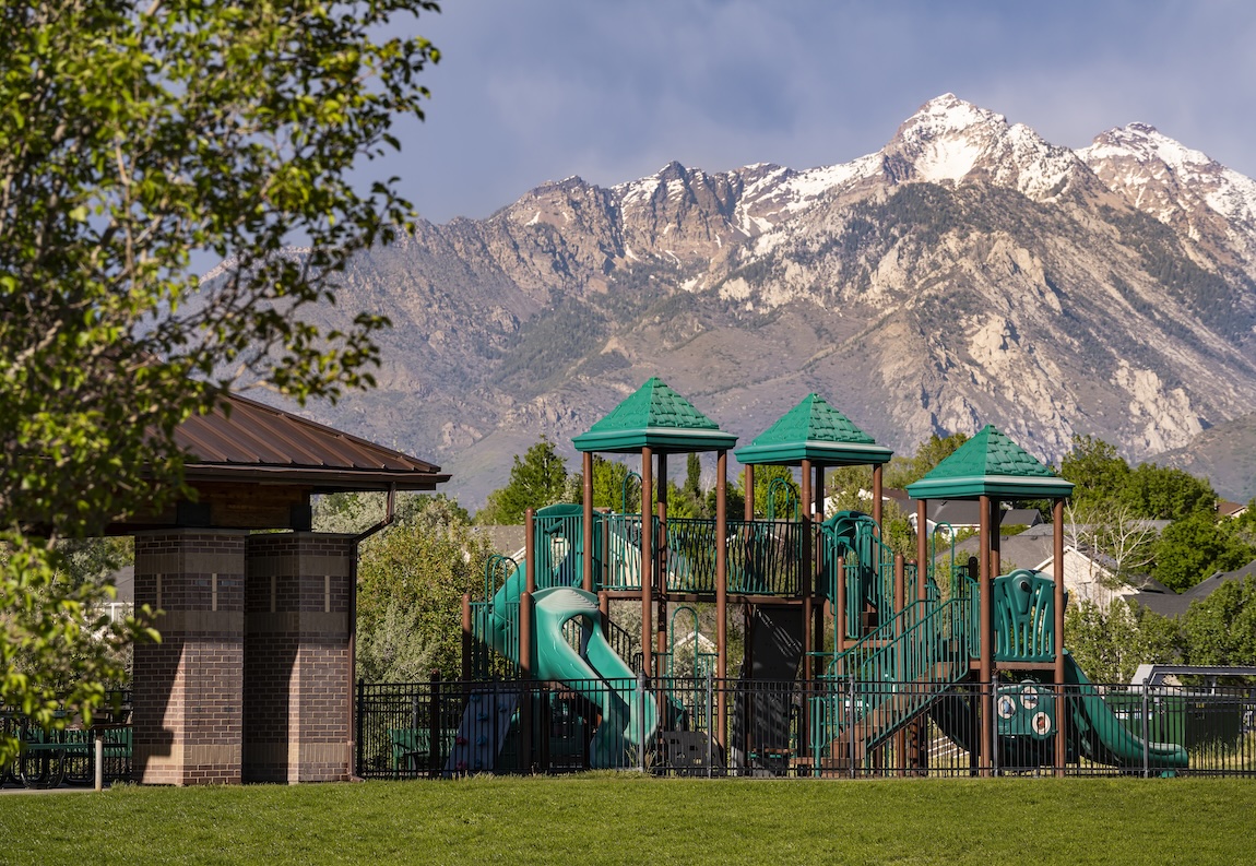 Community playground with mountain views, green space, and family-friendly outdoor amenities.