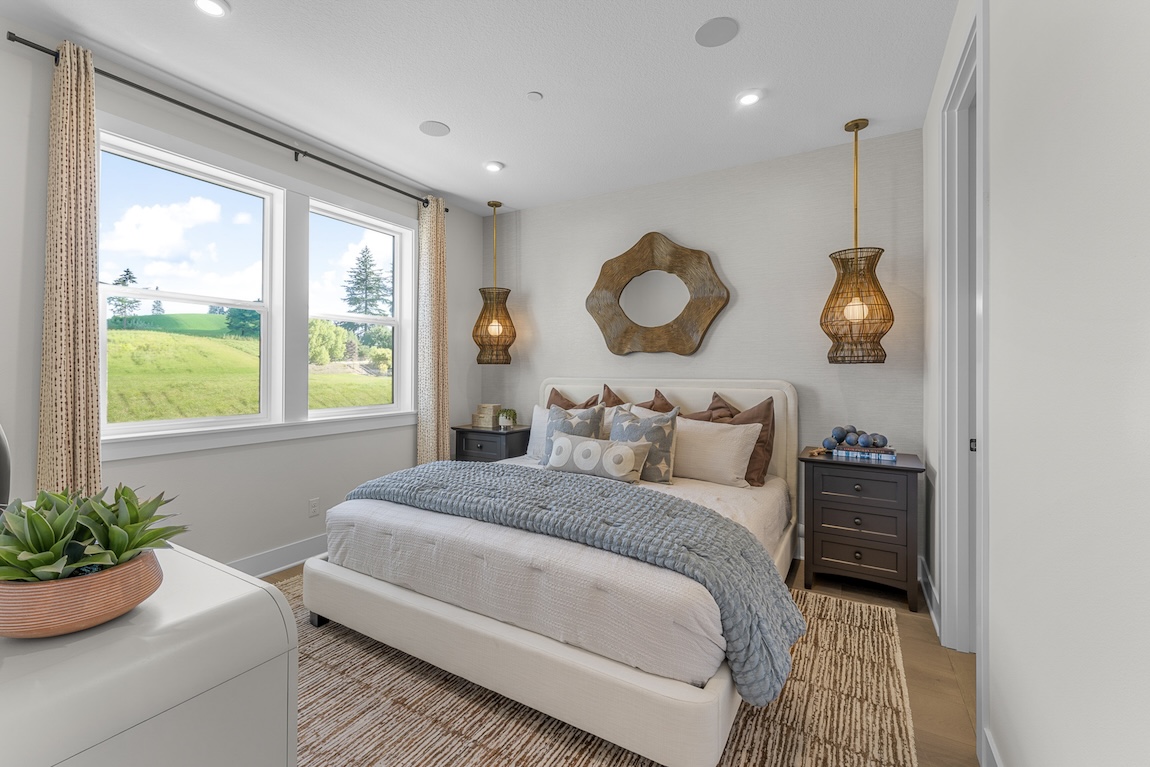 primary bedroom with neutral decor and greenery