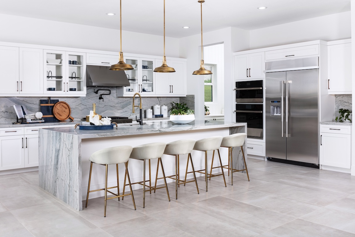 modern kitchen with waterfall island and white barstools