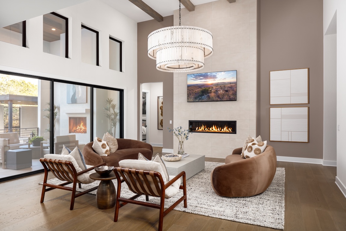 living room with unique seating and a large chandelier