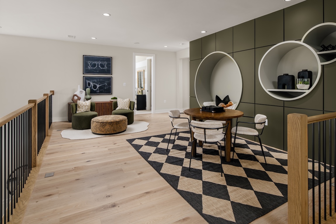 modern loft space with a green accent wall and checkered carpet