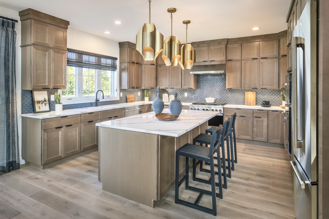 modern kitchen with wooden cabinetry and marble countertops