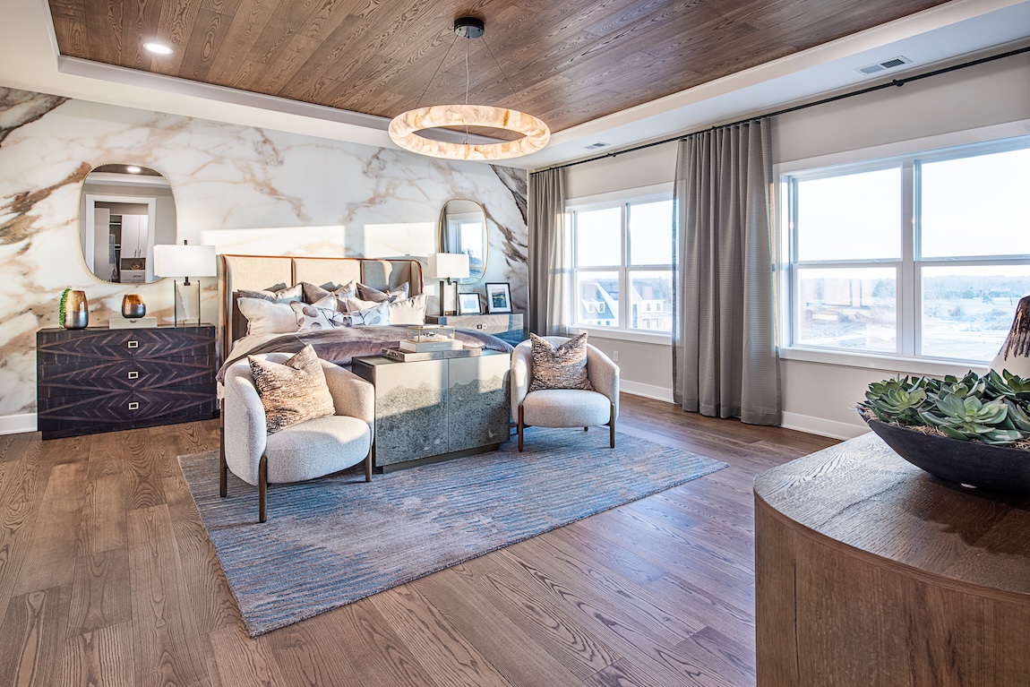primary bedroom with natural light and wood floors