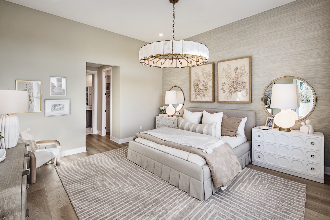 primary bedroom with accent wall and neutral colors.