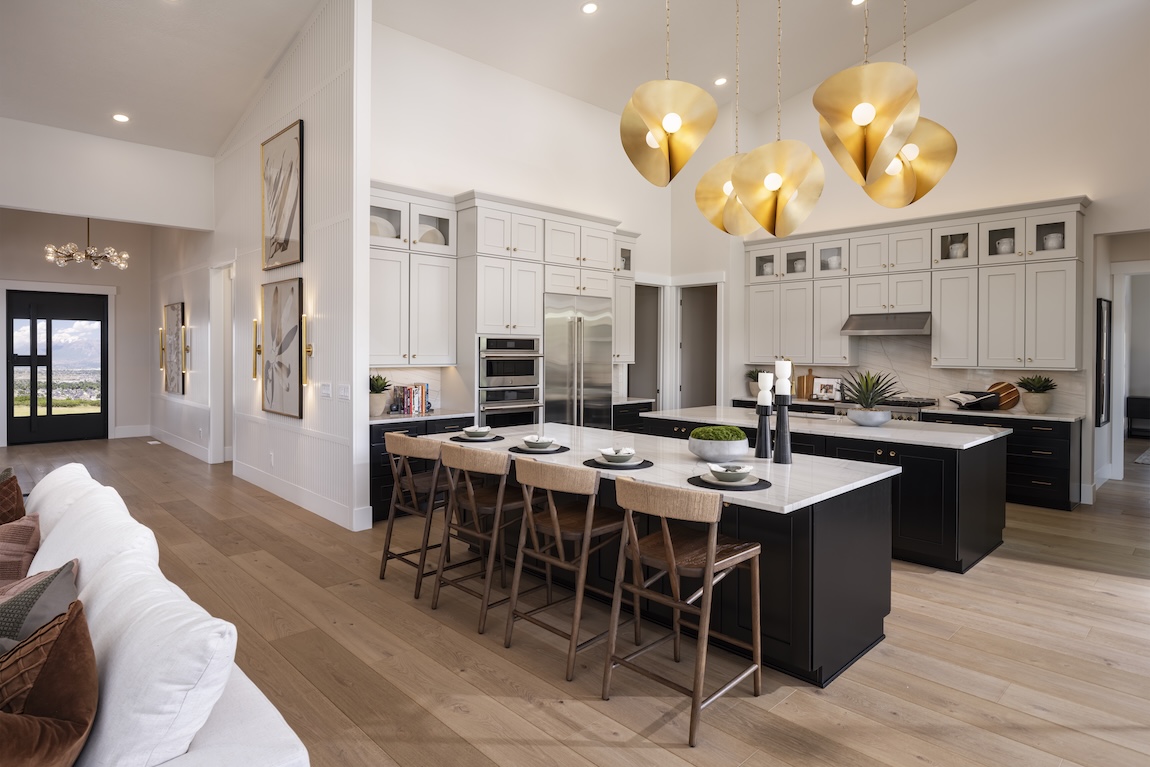 modern kitchen with double islands and statement lighting
