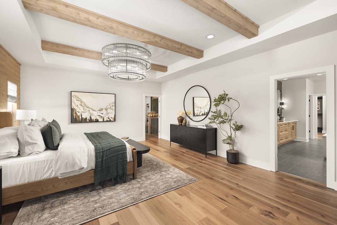 primary bedroom with wooden features and access to the bathroom