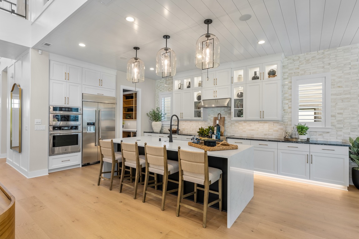 luxe modern farmhouse kitchen with white island and cabinetry