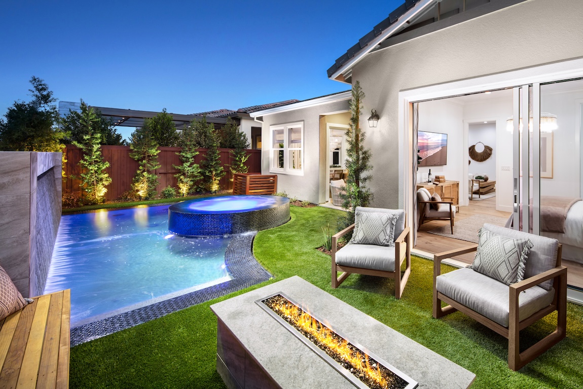 luxury outdoor living space with fire pit and pool