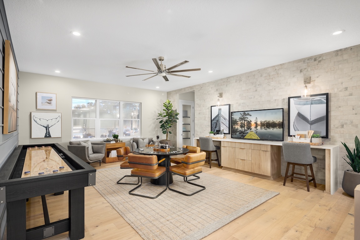 loft space with game table and an accent wall