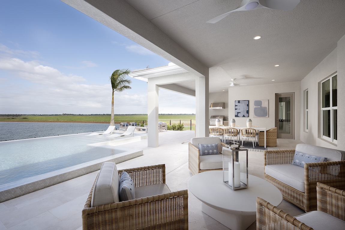 outdoor patio with pool and waterfront views
