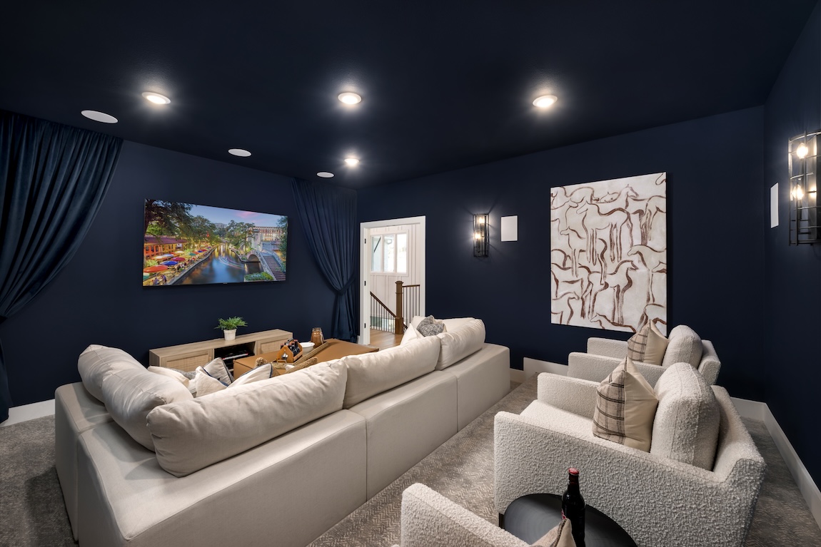 home theater with navy blue walls and comfortable seating