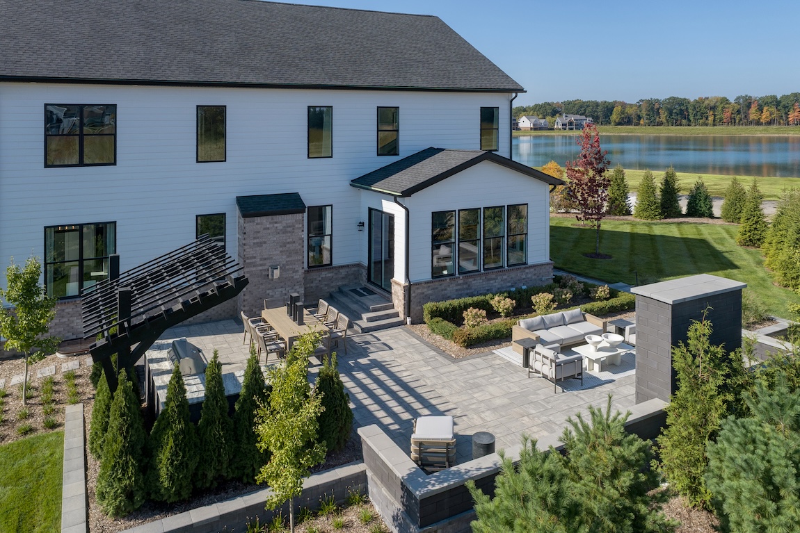 exterior of home with patio space and water views.
