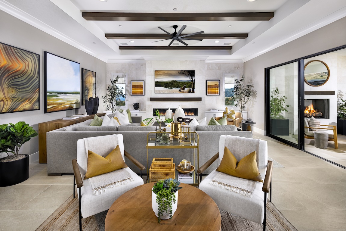 modern great room with yellow hues and wood beam ceilings