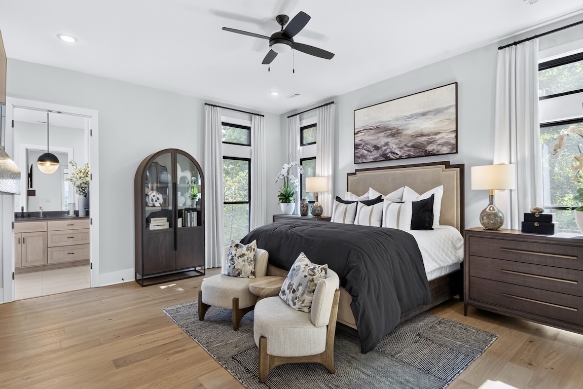 primary bedroom with black features and access to the bathroom
