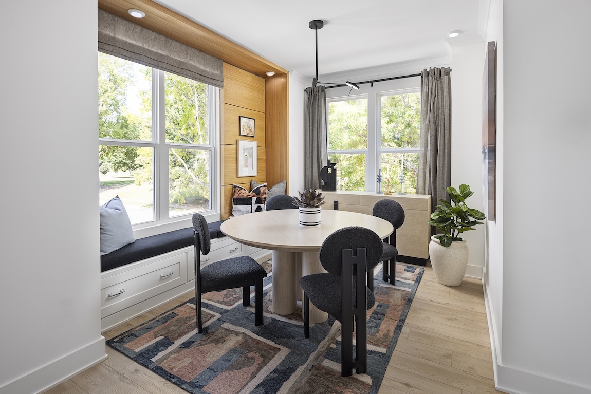 modern dining room with patterned carpet and wooden features.