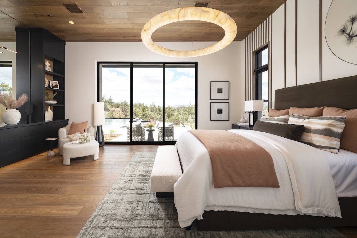 Modern bedroom with terracotta accents, wood ceiling, black built-ins, and pool views