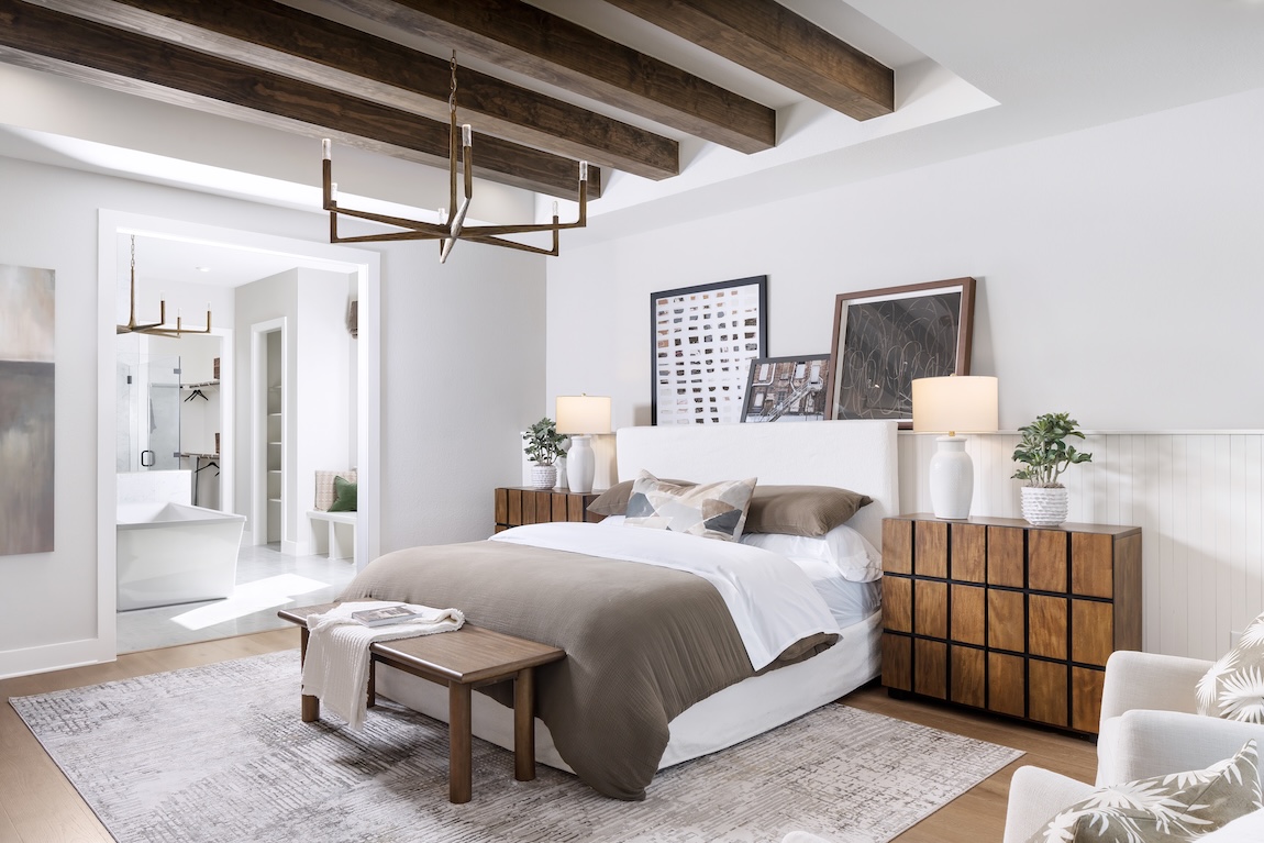 primary bedroom with wood beam ceilings