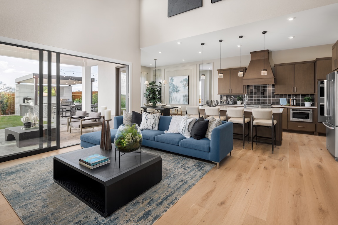 modern living room with blue couch and wooden cabinetry