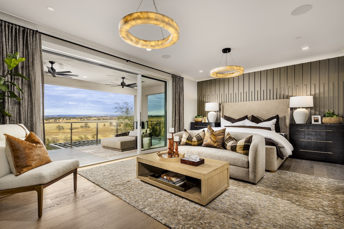 modern primary bedroom with glass doors to patio