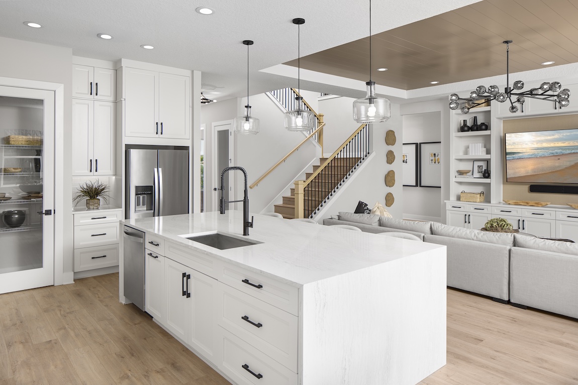 modern kitchen with marble island and black fixtures.