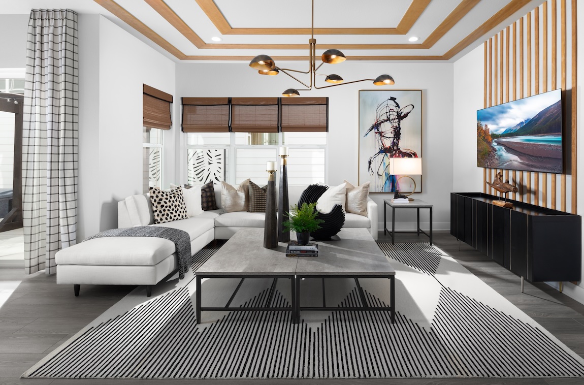 Neo Deco great room with geometric patterns, sculptural lighting, wood trim, and black-and-white furnishings.