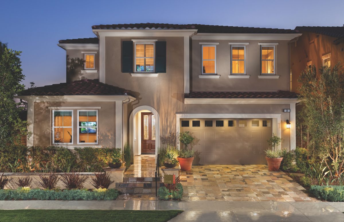 Home exterior with lights on inside.
