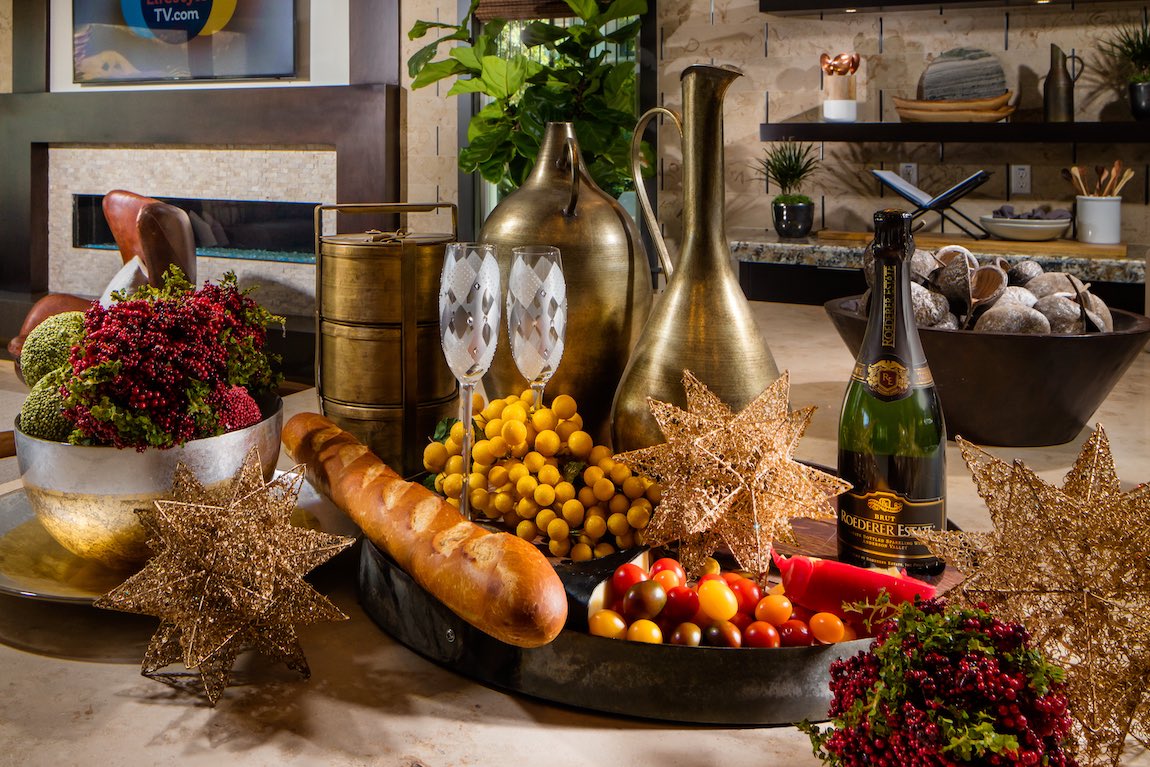 Holiday Christmas food spread on kitchen island with star decorations and gold metal pitchers