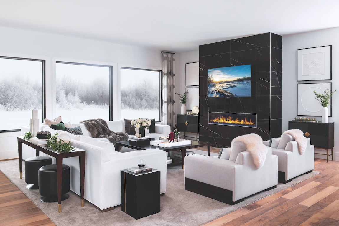 Modern living room with white sofas, dark grey fleece blanket, black marble fireplace, and matte black furniture accents