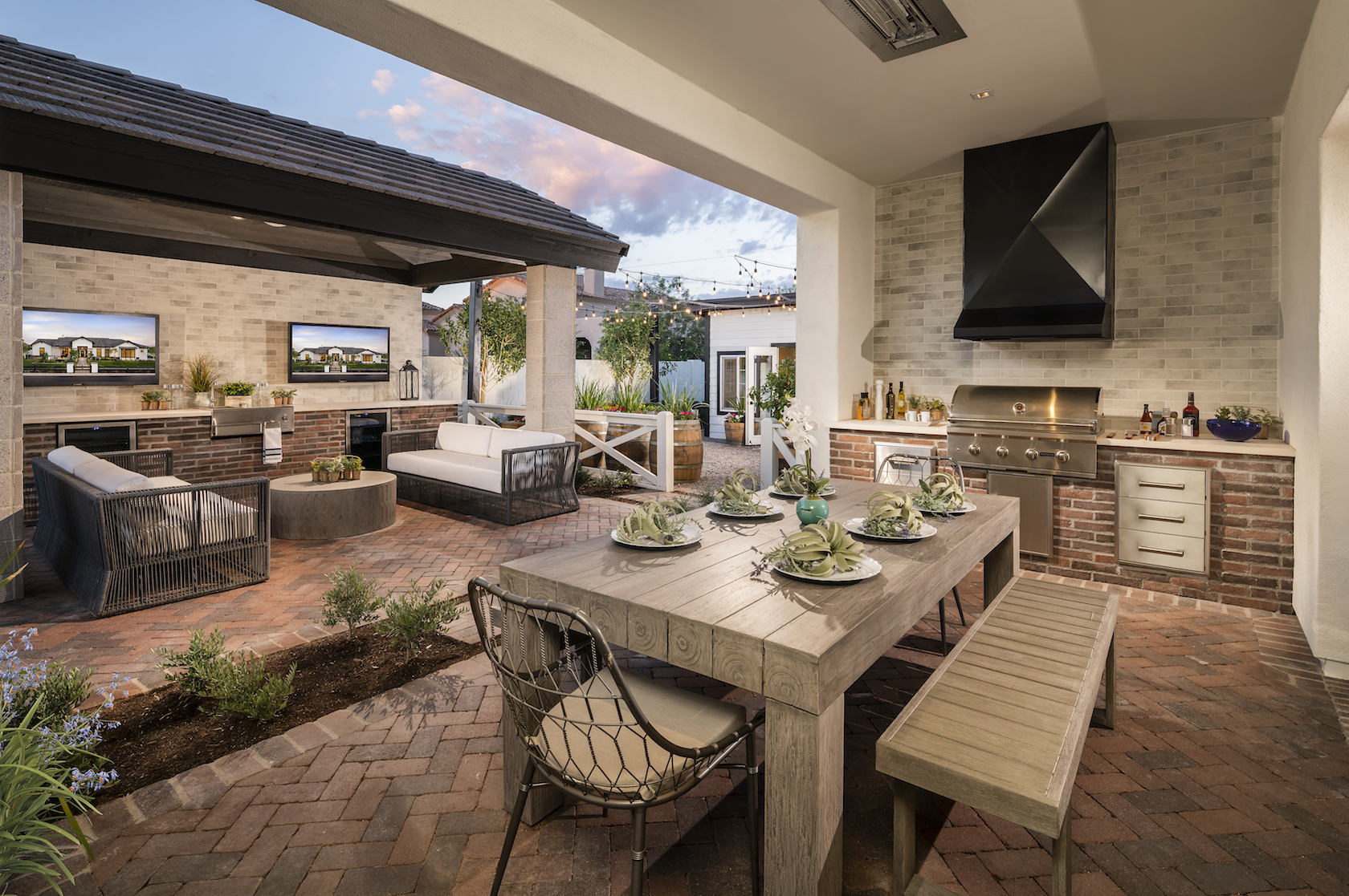Outdoor patio wit grill and couches.