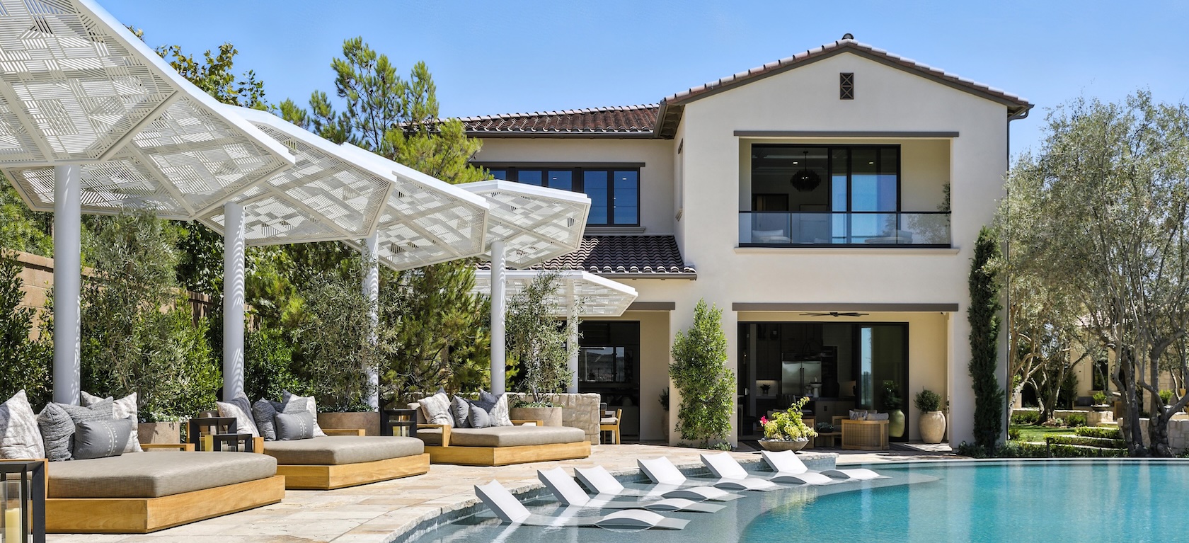 exterior of home with large pool and pergola