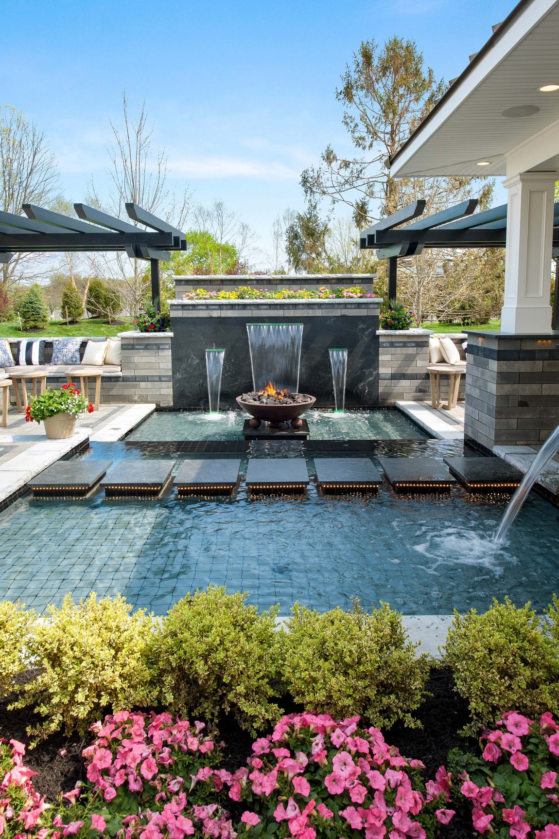Outdoor area with pool and waterfall in a multigenerational home