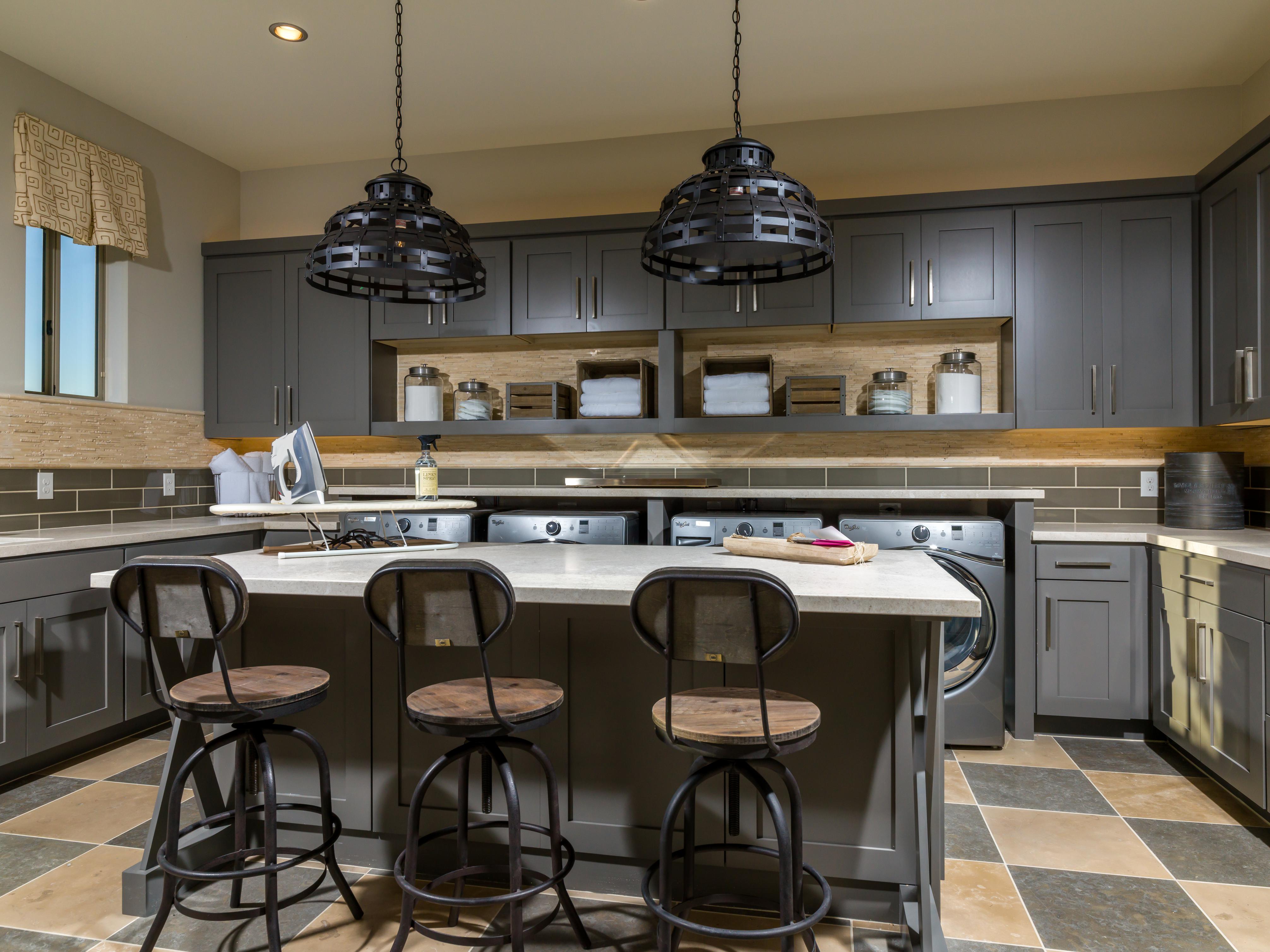 Laundry room with a center island and barstools.